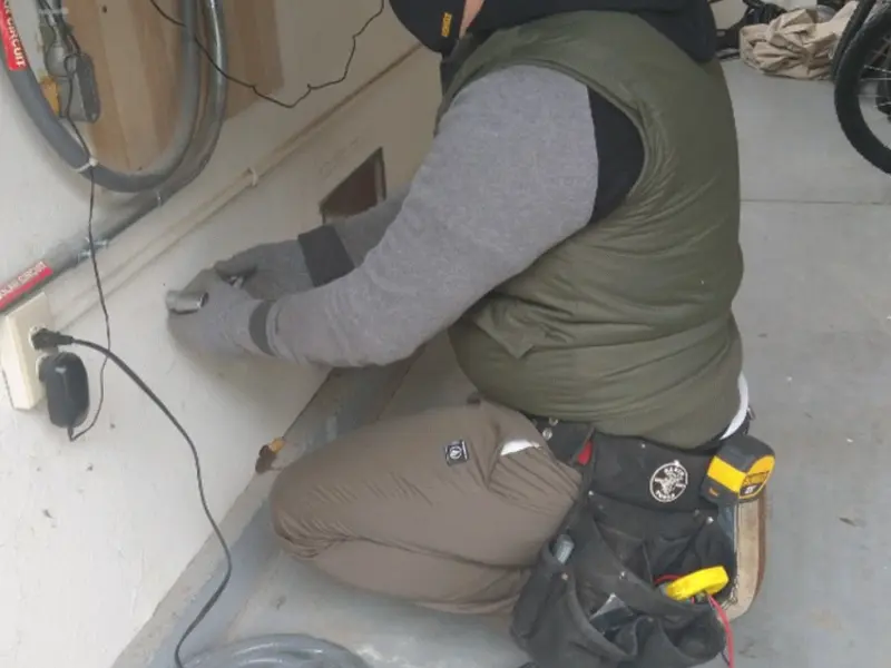 Electrician performing outlet wiring in a Smithville garage